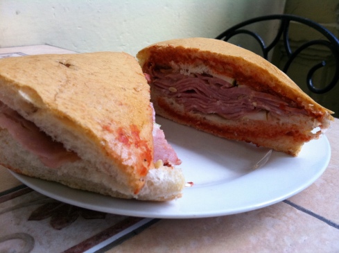 A Media Noche sandwich, filled with ham and cheese and some salsa, is a common sight on the streets of Havana